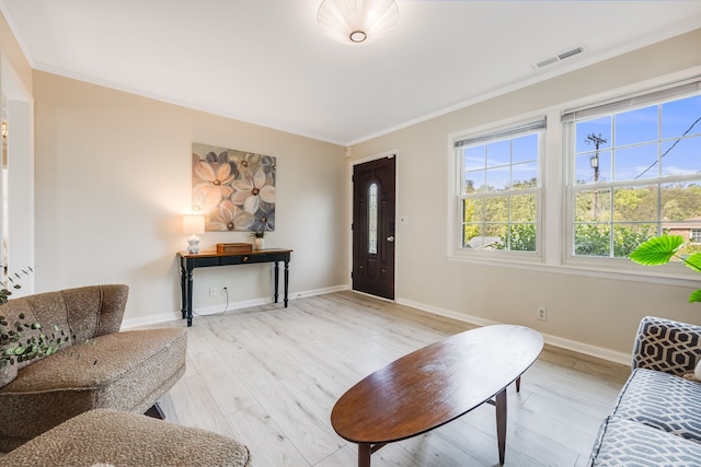 living room featuring ornamental molding and light hardwood / wood-style flooring