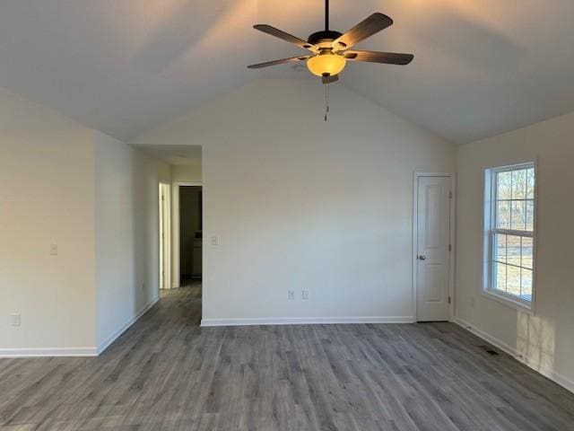 spare room with ceiling fan, lofted ceiling, and dark hardwood / wood-style flooring