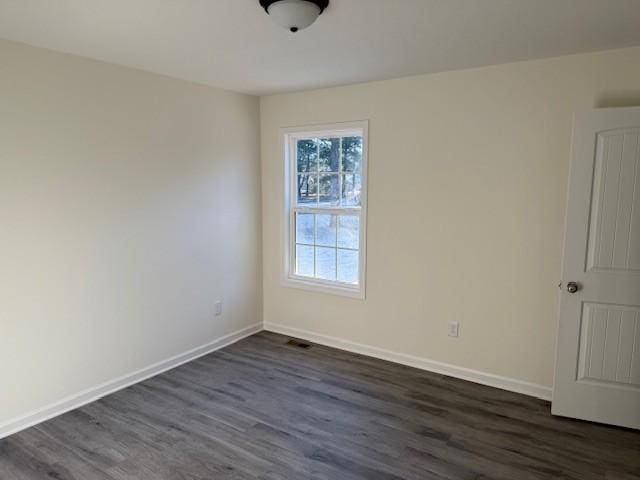 empty room featuring dark hardwood / wood-style flooring