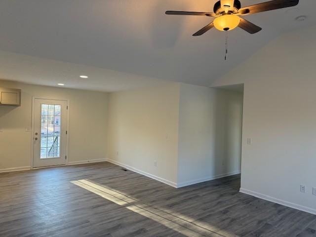 unfurnished room with dark hardwood / wood-style flooring, lofted ceiling, and ceiling fan