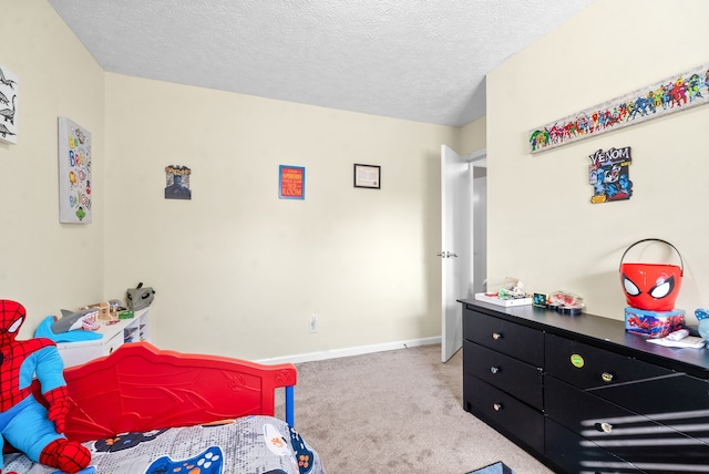 bedroom featuring light carpet and a textured ceiling