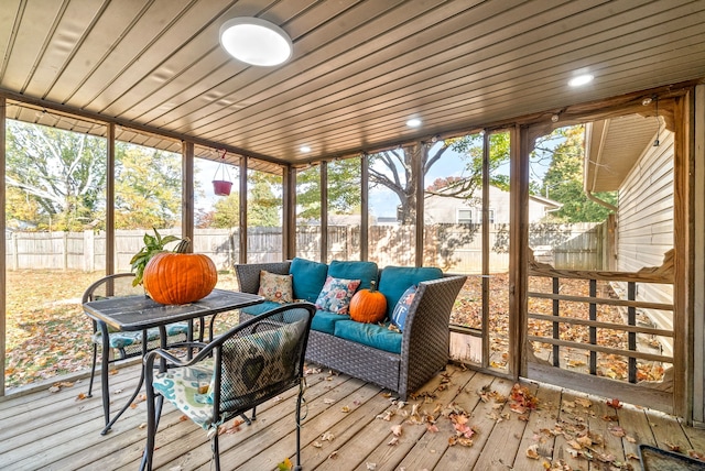 sunroom / solarium with a healthy amount of sunlight and wooden ceiling