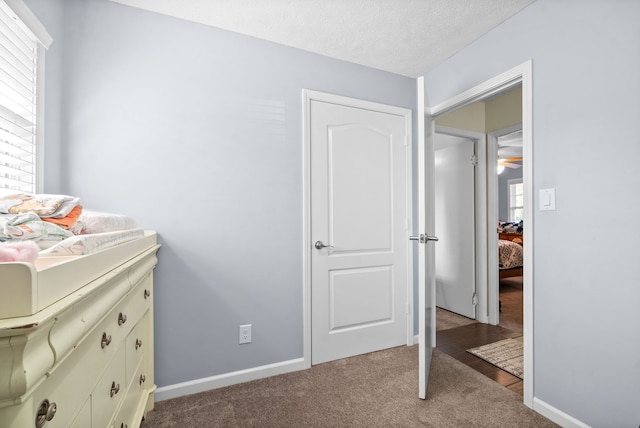 carpeted bedroom with a textured ceiling