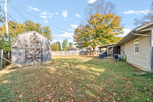 view of yard featuring a storage unit and central AC unit