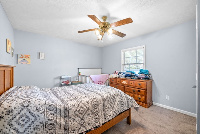 carpeted bedroom with a textured ceiling and ceiling fan