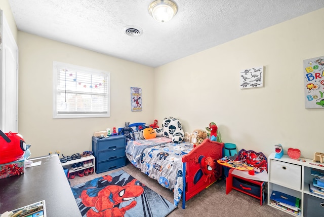 bedroom featuring carpet floors and a textured ceiling