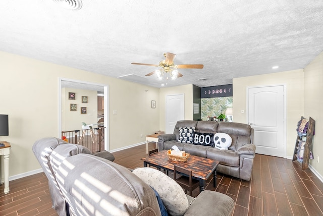 living room with dark wood-type flooring, a textured ceiling, and ceiling fan