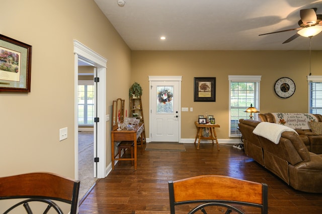 living room with ceiling fan, a wealth of natural light, and dark hardwood / wood-style flooring