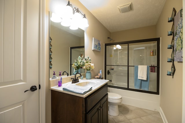 full bathroom with tile patterned floors, toilet, vanity, enclosed tub / shower combo, and a textured ceiling