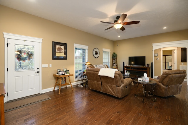 living room featuring ceiling fan and dark hardwood / wood-style flooring