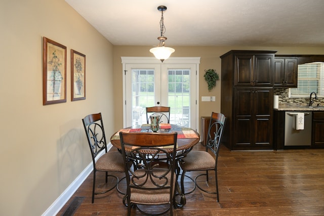 dining area with french doors, sink, and dark wood-type flooring