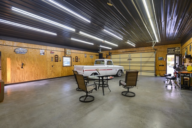 garage featuring wood walls