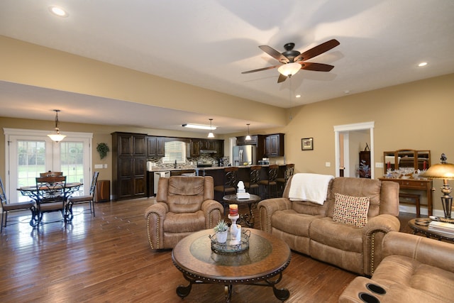 living room featuring dark hardwood / wood-style floors and ceiling fan