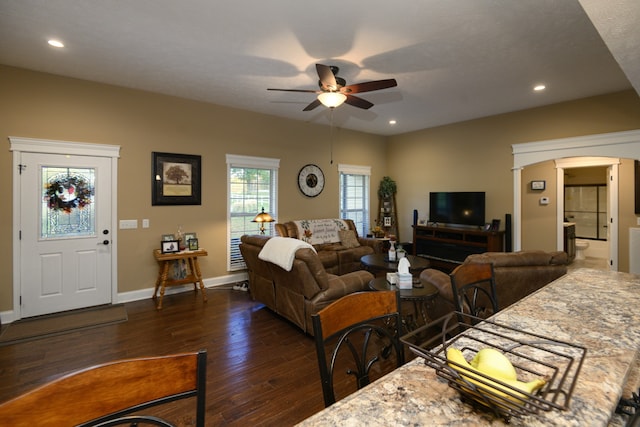 living room featuring dark hardwood / wood-style floors and ceiling fan