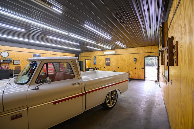 garage featuring wood walls