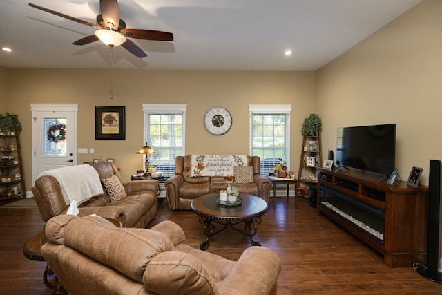 living room with dark wood-type flooring and ceiling fan