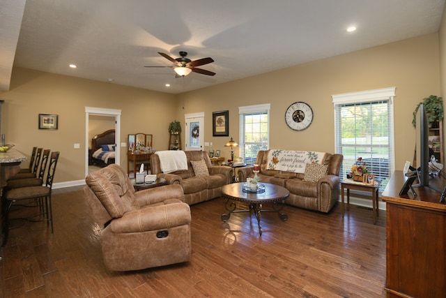 living room with dark wood-type flooring and ceiling fan