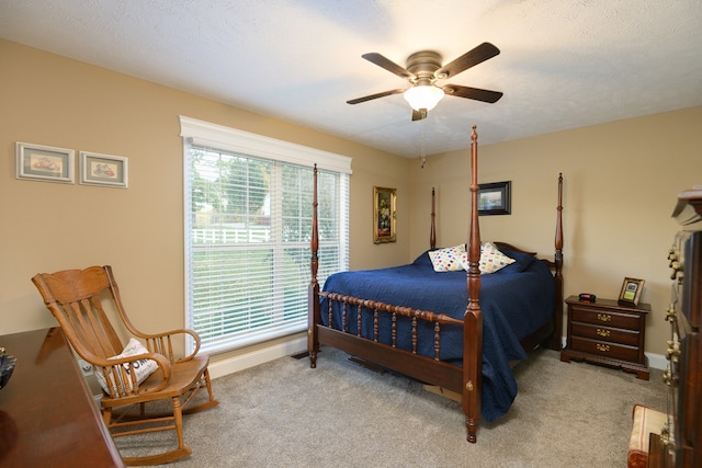 bedroom with light carpet, a textured ceiling, and ceiling fan