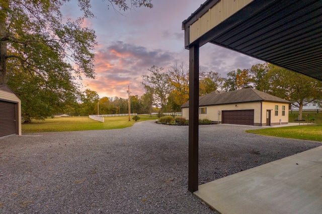 yard at dusk with a garage