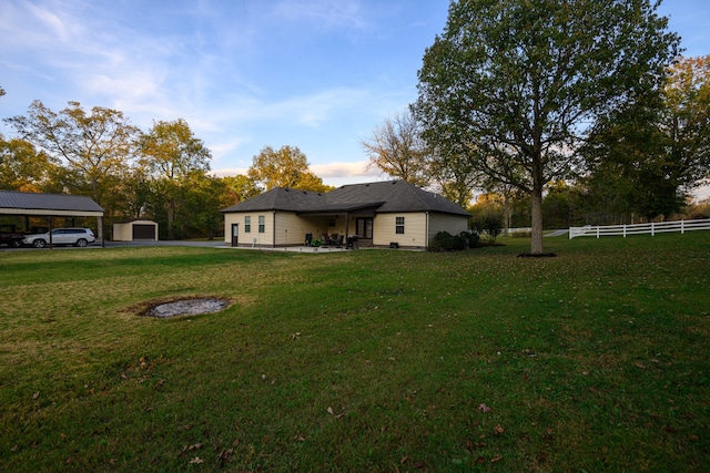 view of yard featuring a storage shed and a carport