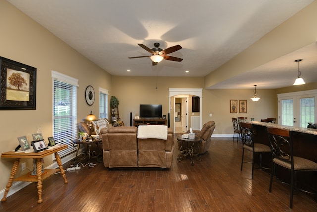 living room featuring ceiling fan and dark hardwood / wood-style flooring