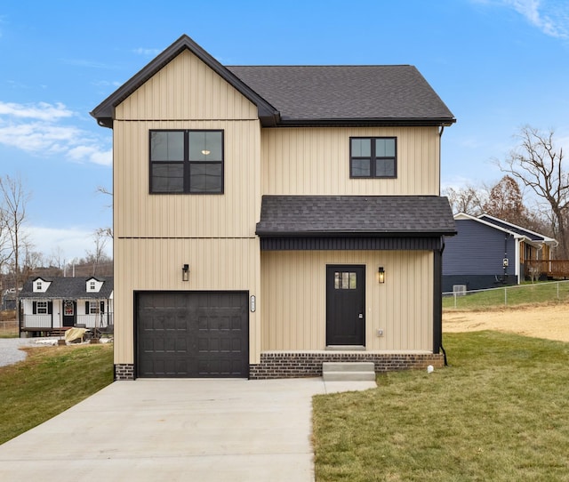 view of front of house featuring a front yard and a garage