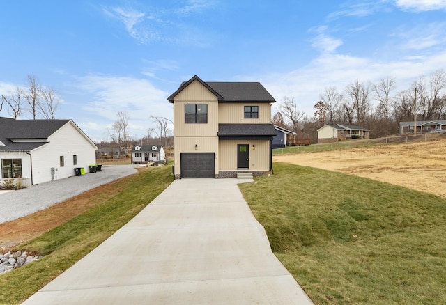 view of front of home with a garage and a front lawn