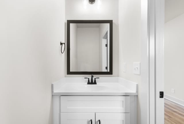 bathroom with vanity and wood-type flooring