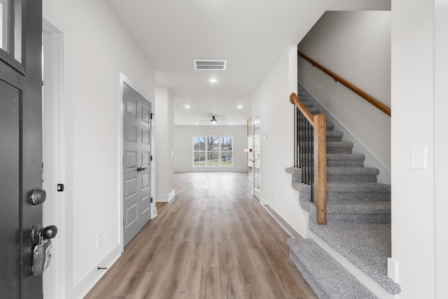 foyer with wood-type flooring and ceiling fan