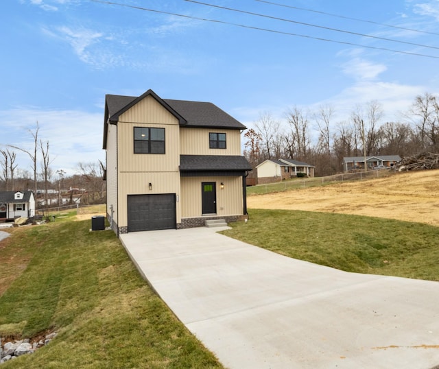 view of front of property with central AC unit, a garage, and a front lawn