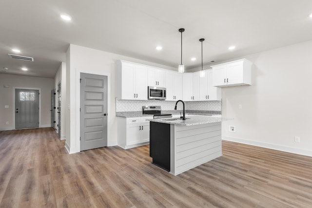 kitchen featuring white cabinetry, light wood-type flooring, and appliances with stainless steel finishes