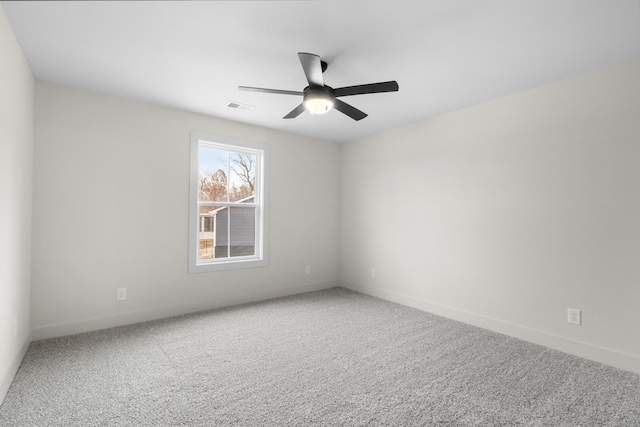 spare room with ceiling fan and carpet