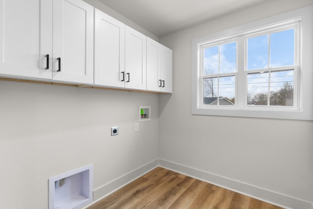 washroom with electric dryer hookup, cabinets, wood-type flooring, and hookup for a washing machine