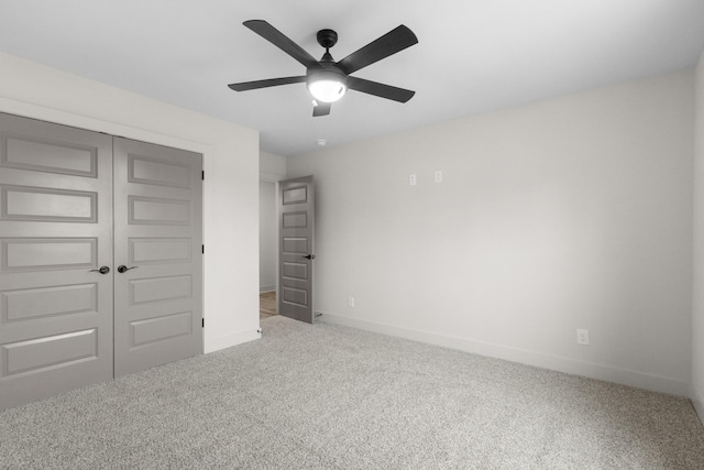 unfurnished bedroom featuring carpet flooring, a closet, and ceiling fan