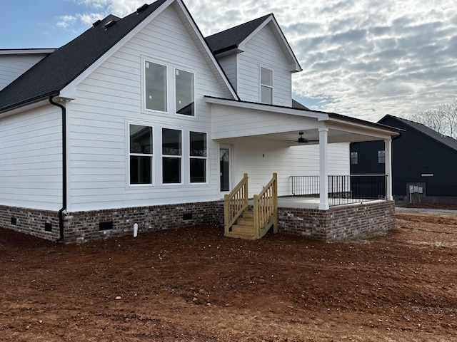 back of house featuring ceiling fan and covered porch