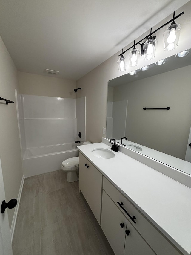 full bathroom with vanity, shower / washtub combination, and toilet