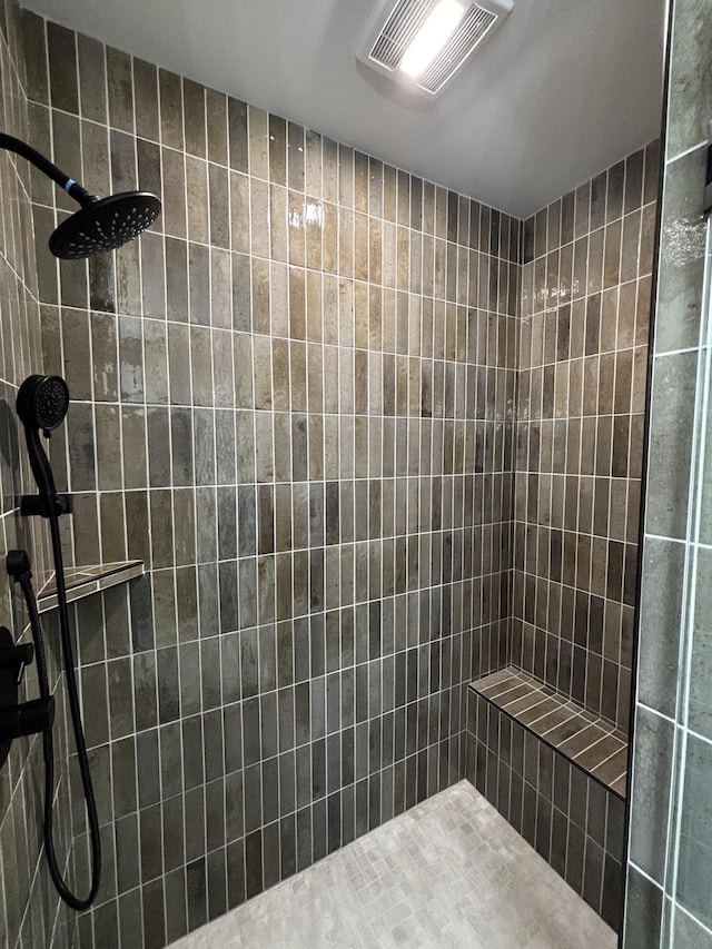 bathroom with tiled shower