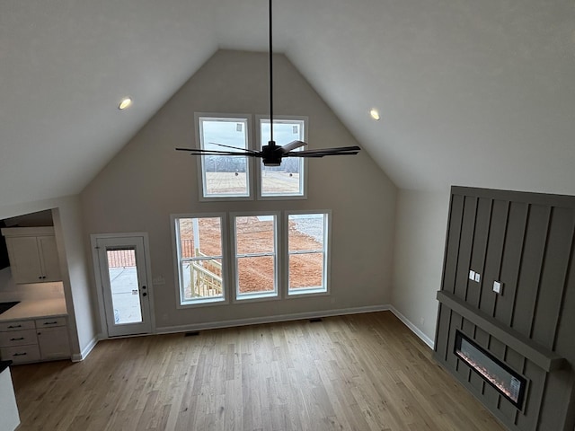 unfurnished living room featuring light hardwood / wood-style flooring and vaulted ceiling