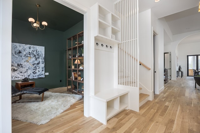 mudroom featuring a notable chandelier and wood-type flooring