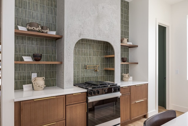 kitchen with light wood-type flooring, gas stove, and tile walls