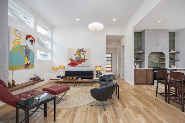 interior space with a large fireplace, a healthy amount of sunlight, and light wood-type flooring