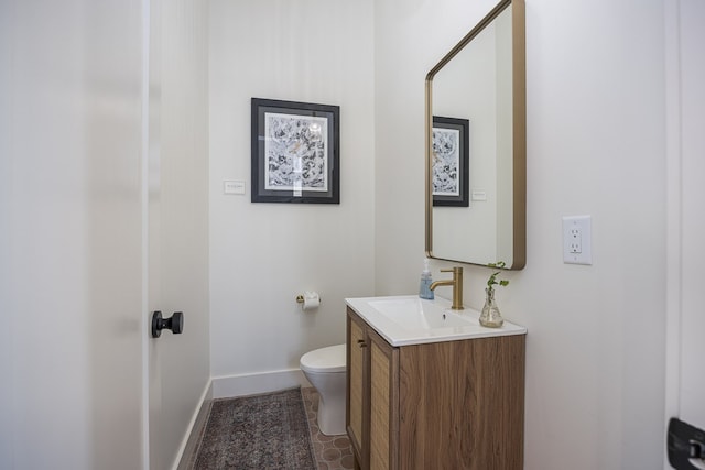 bathroom with tile patterned floors, vanity, and toilet