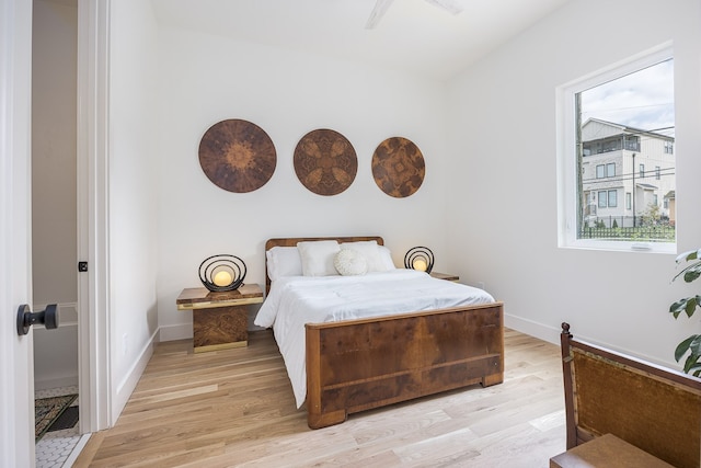 bedroom with light hardwood / wood-style floors and ceiling fan