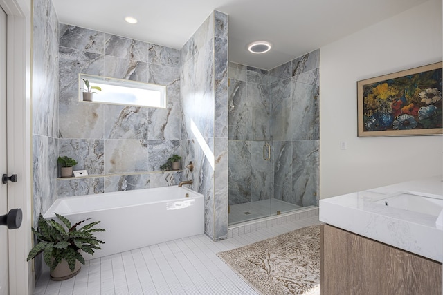 bathroom featuring tile patterned floors, separate shower and tub, and vanity