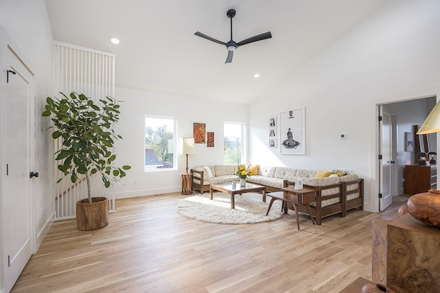 living room with high vaulted ceiling, light hardwood / wood-style flooring, and ceiling fan