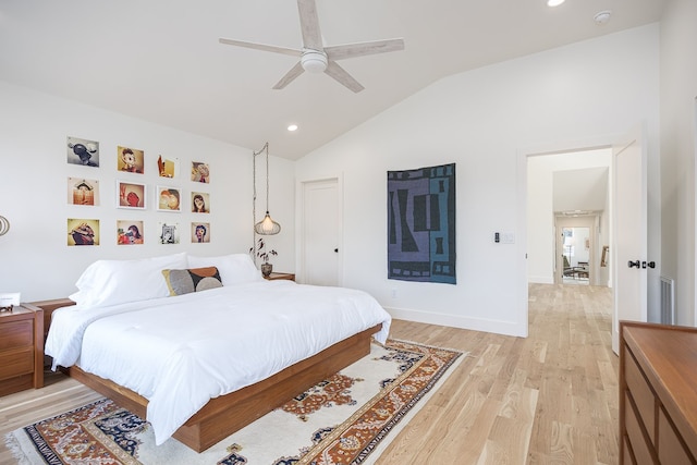 bedroom with ceiling fan, light hardwood / wood-style flooring, and lofted ceiling