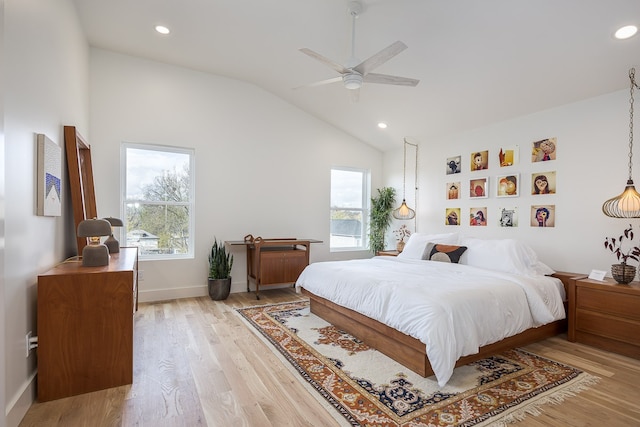 bedroom featuring multiple windows, ceiling fan, light hardwood / wood-style flooring, and vaulted ceiling