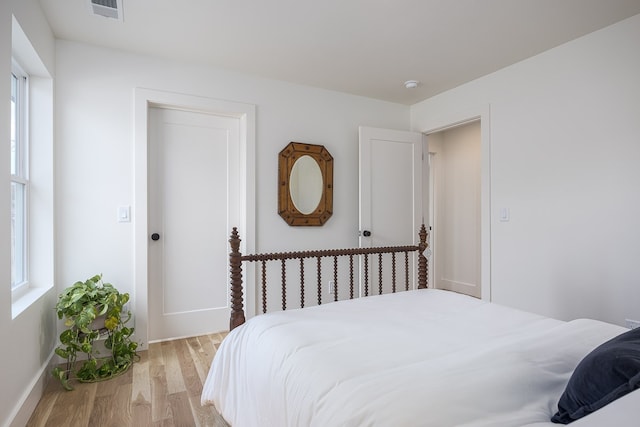 bedroom featuring light wood-type flooring and multiple windows