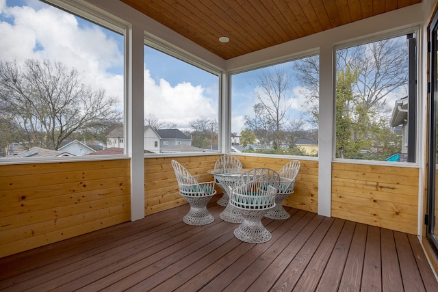 unfurnished sunroom with plenty of natural light and wooden ceiling