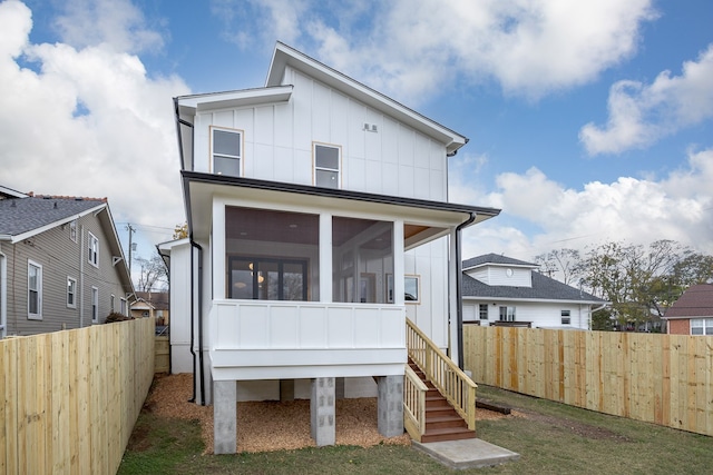 back of house featuring a sunroom